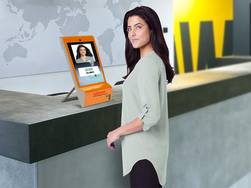 Portable kiosk placed on reception desk and visitor stand infront of it